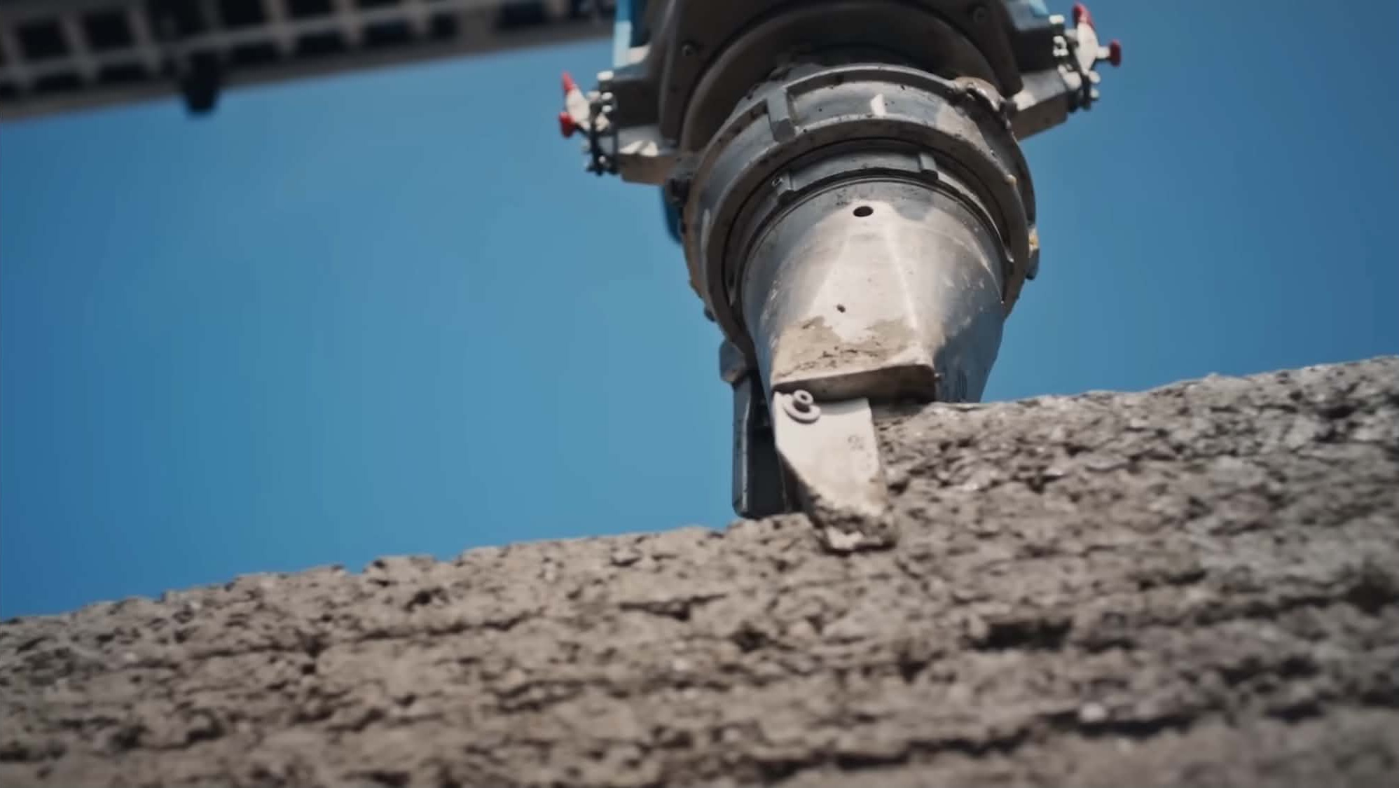 COBOD robotic print head in action extruding concrete during a nidus3D build