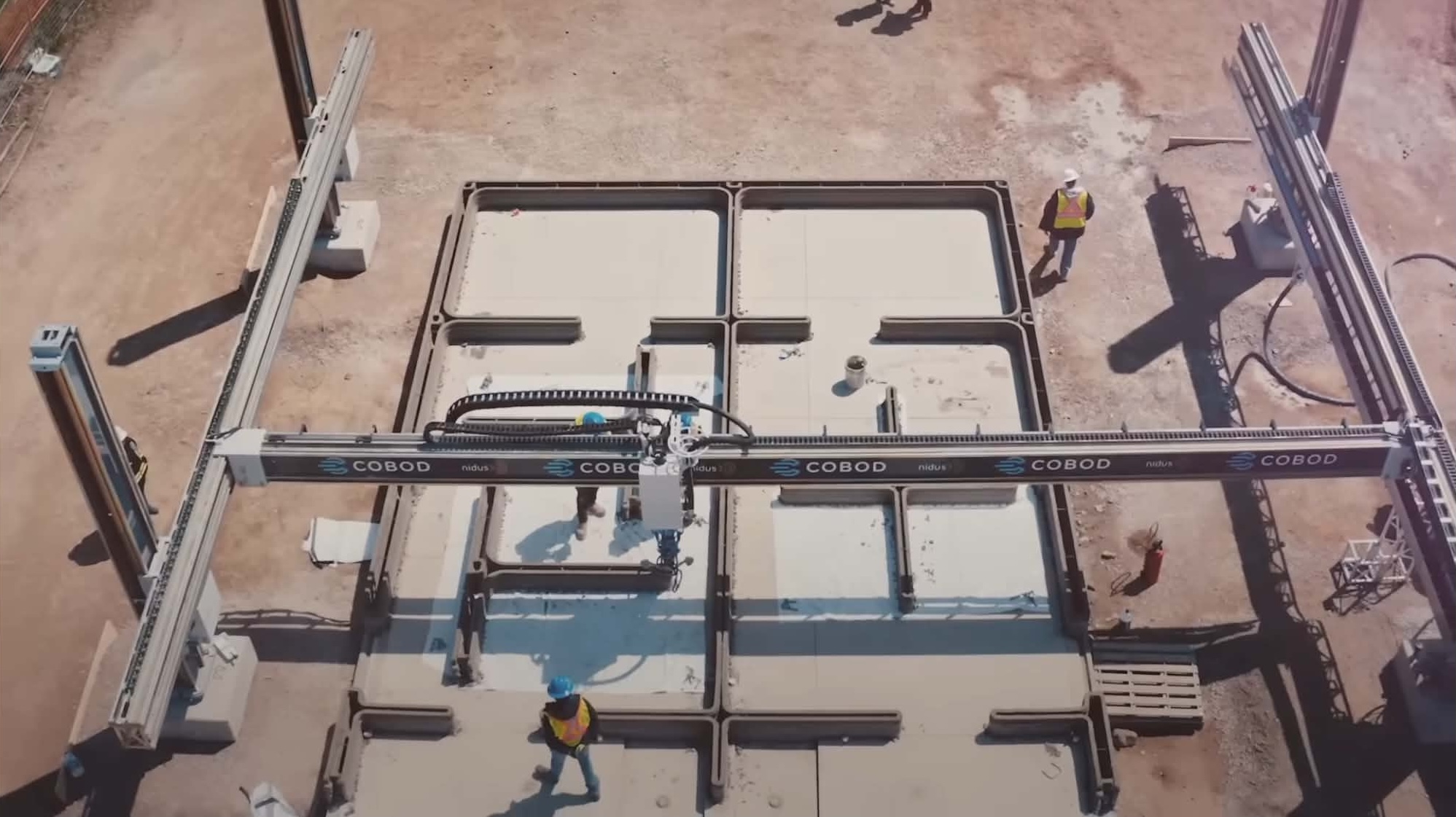 Overhead aerial view of 3D printed concrete foundation layout and COBOD gantry system
