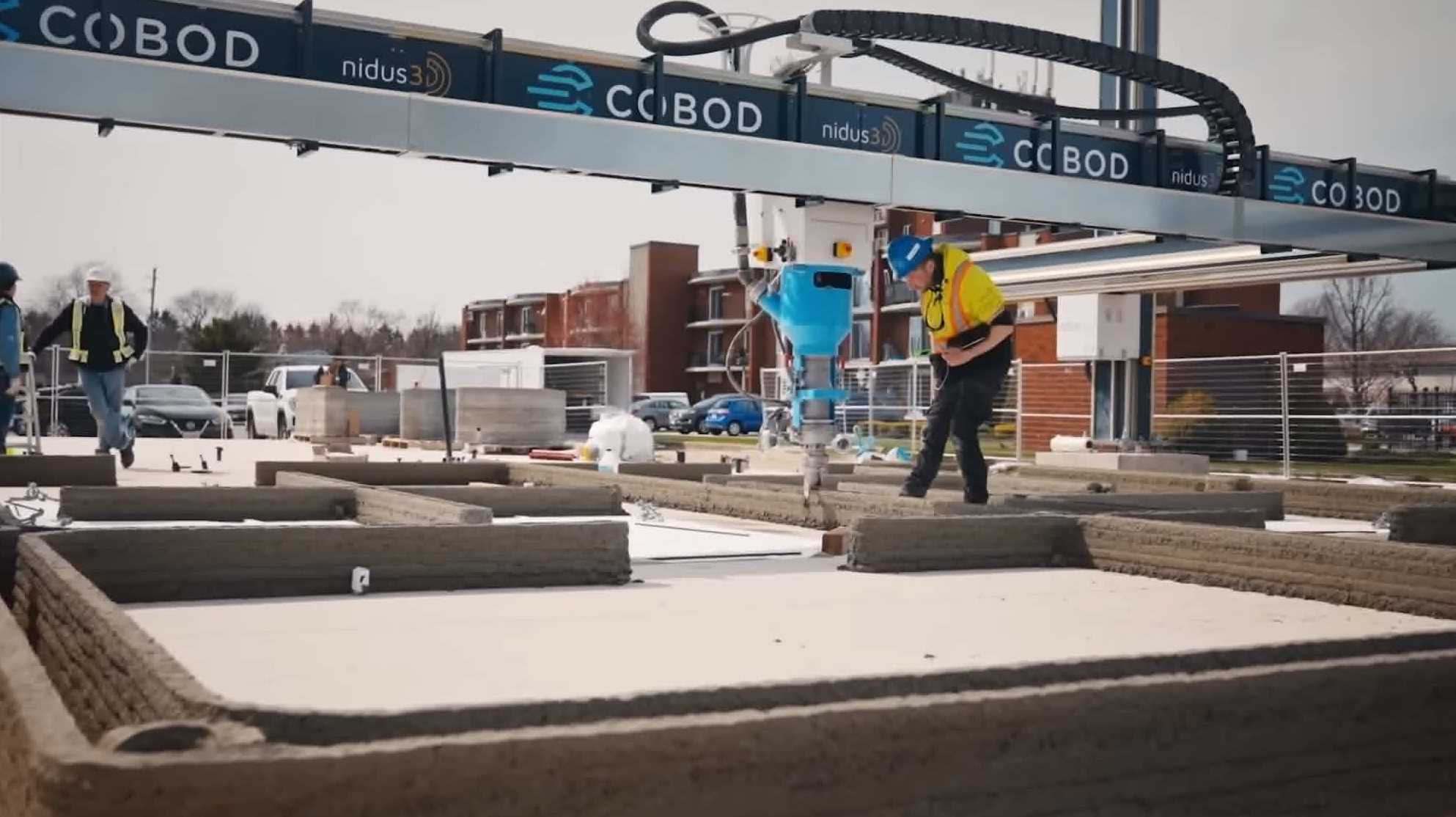 Construction worker operating nidus3D's COBOD 3D concrete printer on a residential project in Kingston, Ontario